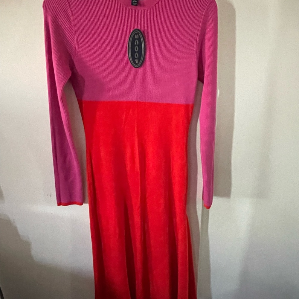 Asymmetric, pink and orange knit long sleeve dress. Hugs the figure.